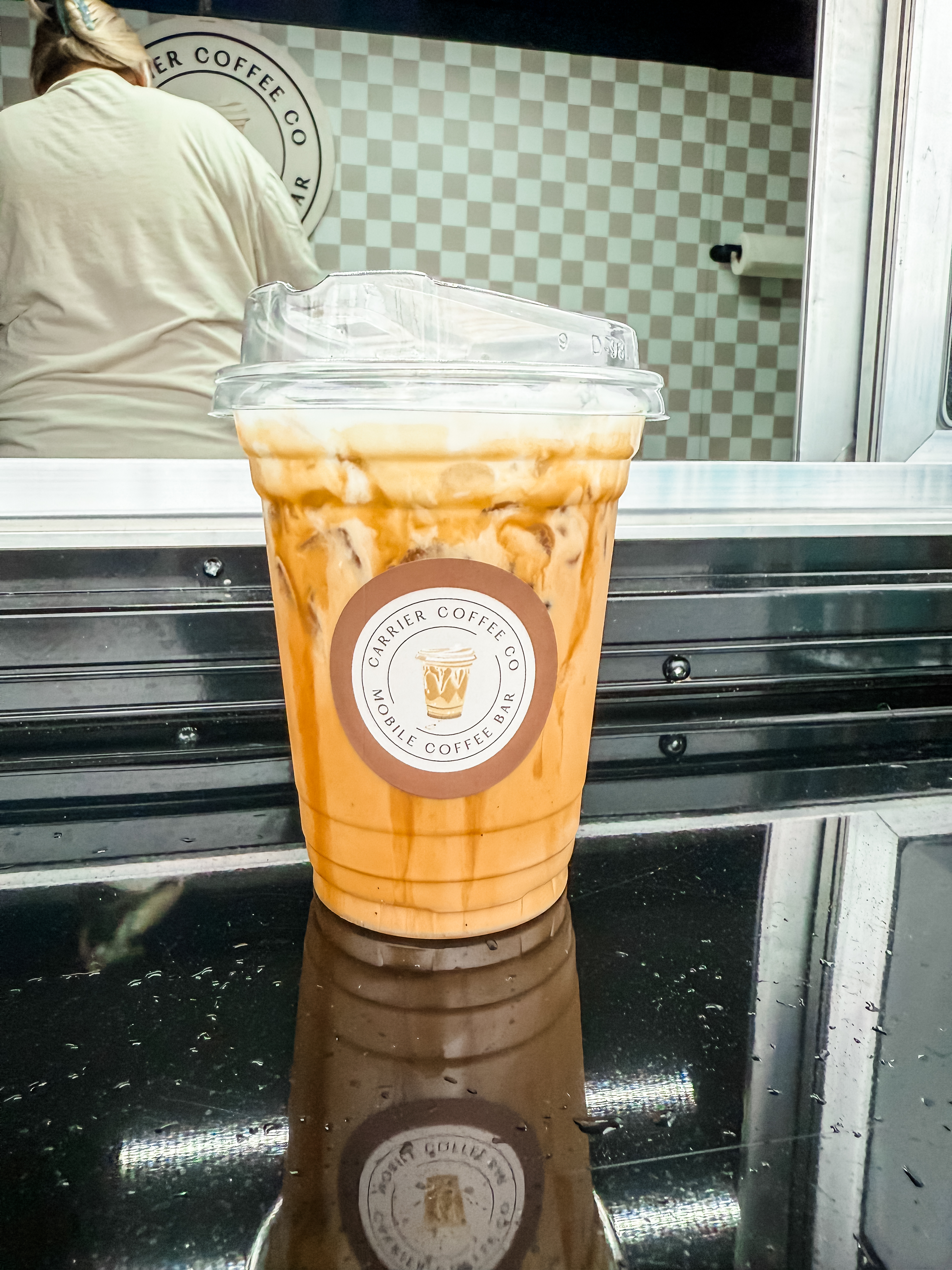 An iced latte on the trailer counter
