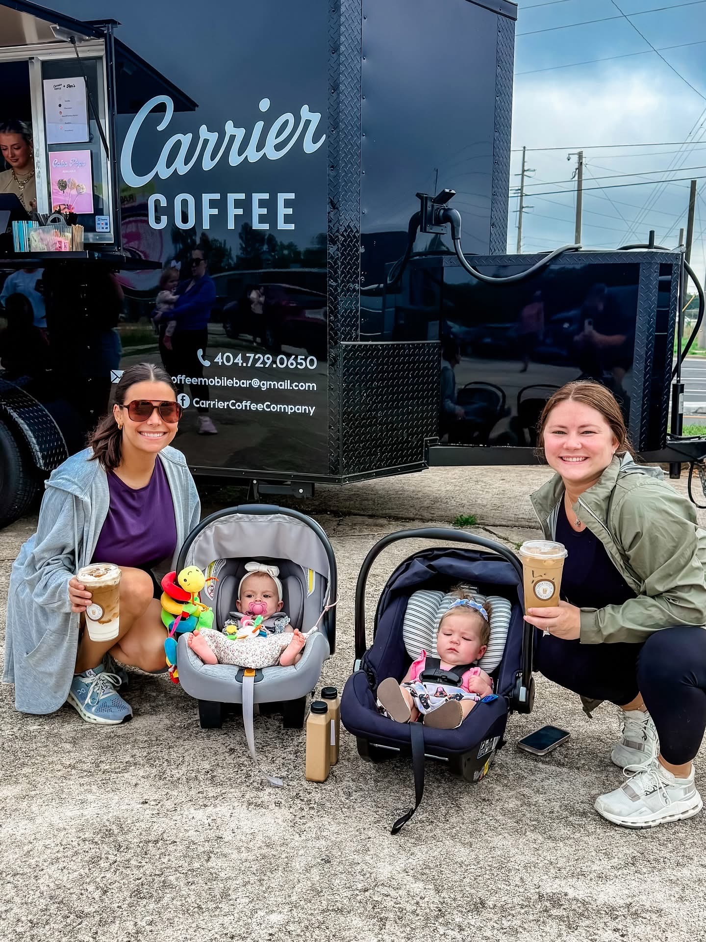Two friends with Carrier coffees at the market