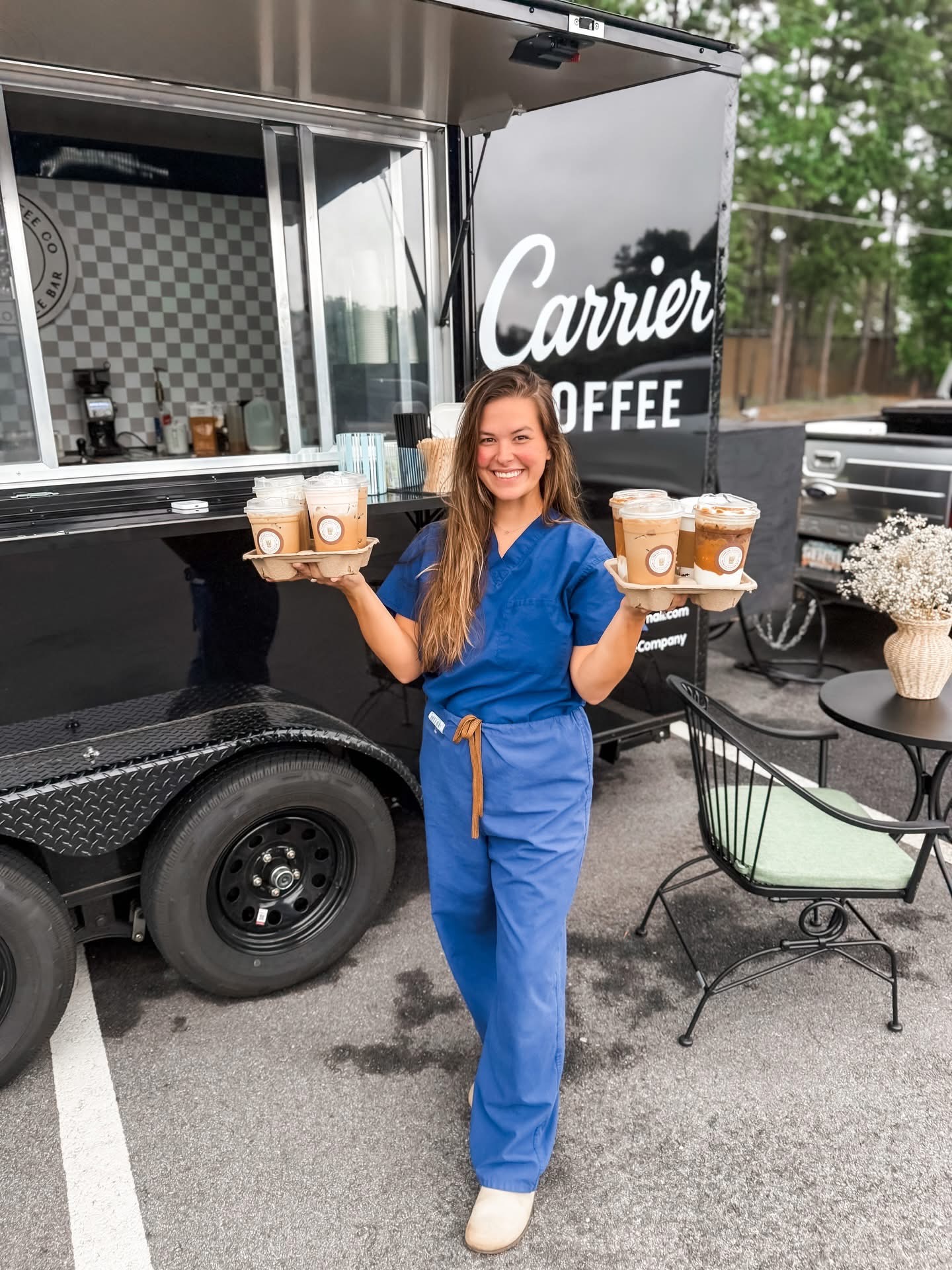 Carrying trays of Carrier drinks from the trailer